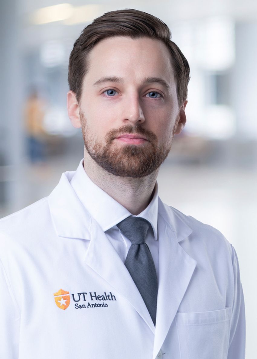 Kevin Koronowski, a chronobiologist at the University of Texas, San Antonio, looks at the camera for a photograph. He has short dark hair, blue eyes, and is wearing a white lab coat with the words “UT Health San Antonio” on the left side. Kevin Koronowski, a chronobiologist at the University of Texas, San Antonio, looks at the camera for a photograph. He has short dark hair, blue eyes, and is wearing a white lab coat with the words “UT Health San Antonio” on the left side.