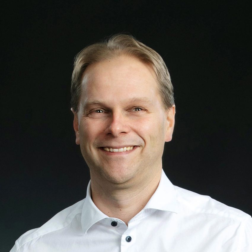 Photograph of Lauri Nummenma, a neuroscientist and physiologist at the University of Turku. He is wearing a white shirt and is smiling at the camera.