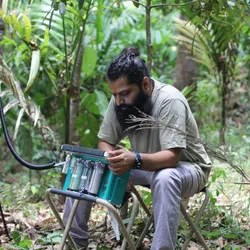 Rakesh Tiwari, a postdoctoral fellow and plant physiologist at Uppsala University, collects photorespiration measurements from plants in the Western Ghats Forest.