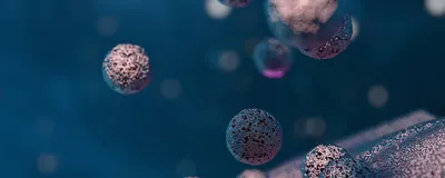 Silvery-purple spheres are released from the surface of a cell against a blue background.