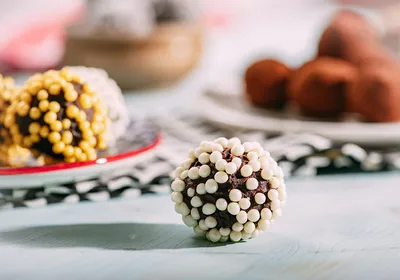 Image of a sugar-coated chocolate truffle on a table. Image of a sugar-coated chocolate truffle on a table.