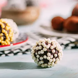 Image of a sugar-coated chocolate truffle on a table.