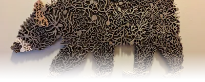 Image of a wooden sculpture comprised of multiple wooden neurons that form a bear.