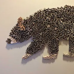 Image of a wooden sculpture comprised of multiple wooden neurons that form a bear.