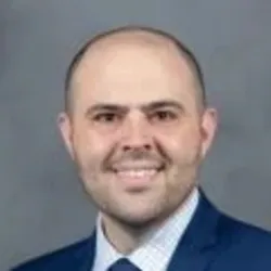 David Avenetti wears a blue suit in a headshot photo.