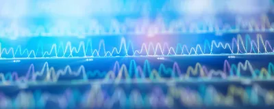 An image of a DNA sequencing spectrum with a radial blur filter applied.