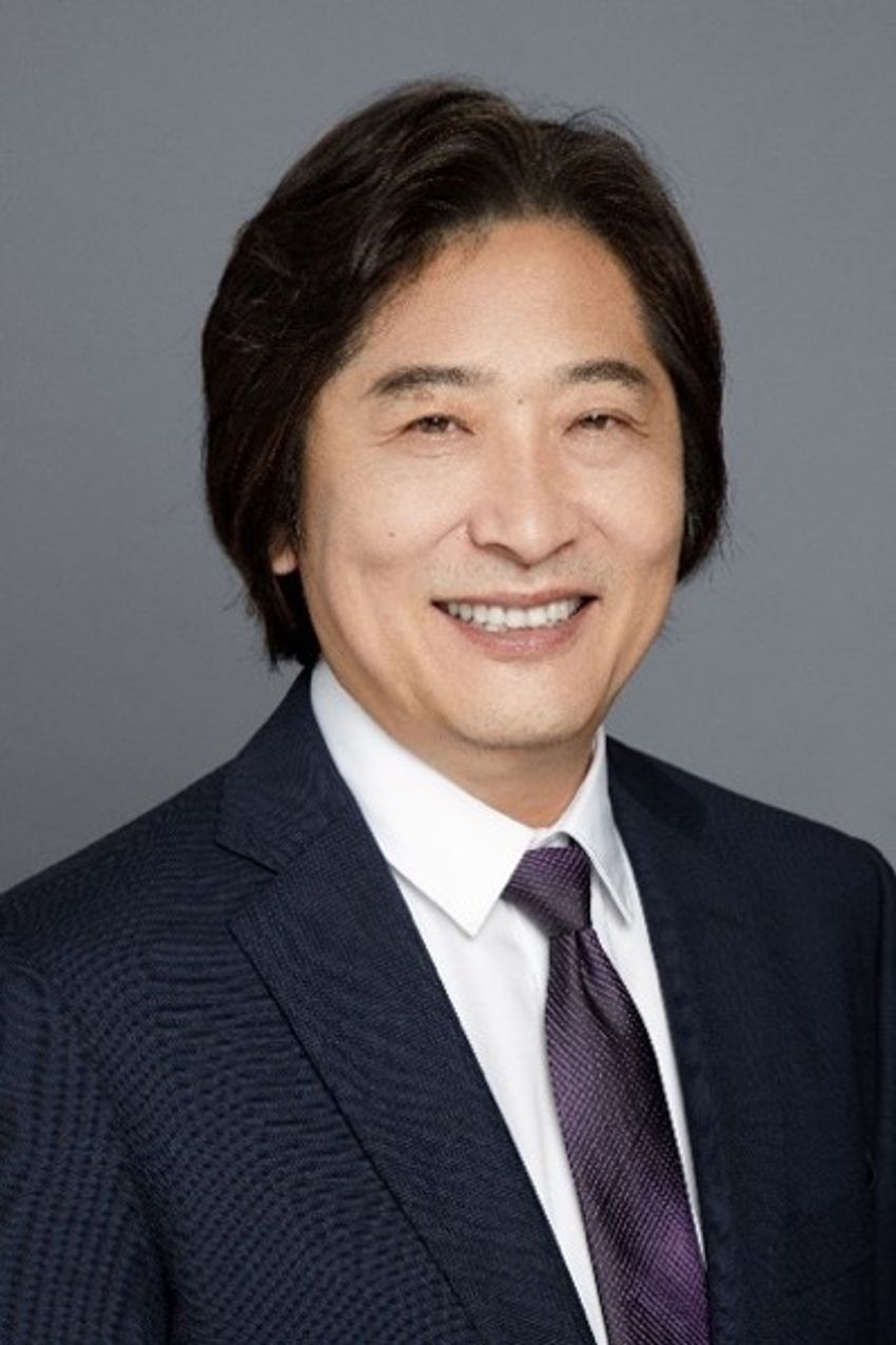 Songtao Shi, who discovered dental pulp stem cells, wears a black blazer, white shirt, and purple tie.