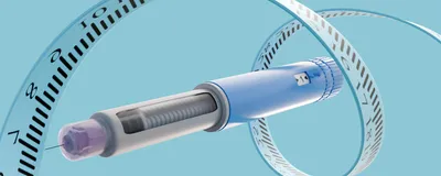 Measuring tape circulates around a GLP-1 drug injector pen, representing the drug’s dramatic effects on weight loss. 
