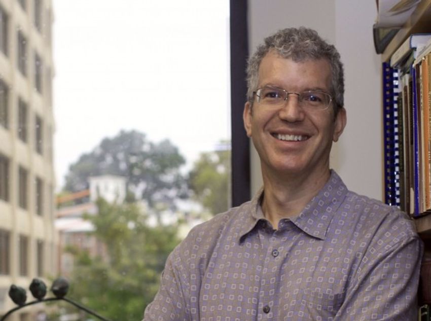 A photograph of Paul Breslin, who studies the genetic basis of human oral perception, wearing a patterned shirt and glasses.