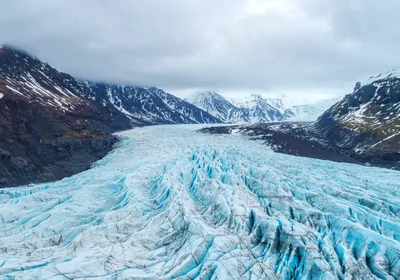 An aerial view of a glacier, which houses millions of microbes within its icy interior. 