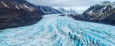 An aerial view of a glacier, which houses millions of microbes within its icy interior. 