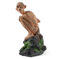 Gollum, the extremely territorial character from The Lord of the Rings, famous for his line, “My precious,” sits on a rock, looking up.  