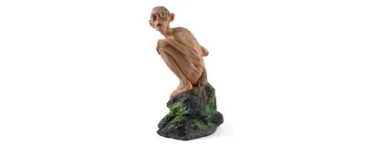 Gollum, the extremely territorial character from The Lord of the Rings, famous for his line, “My precious,” sits on a rock, looking up.