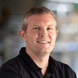 Image of Jesse Dixon. He wears a black shirt and smiles at the camera with his arms crossed. Image of Jesse Dixon. He wears a black shirt and smiles at the camera with his arms crossed.