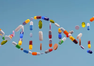 A DNA double helix made up of a variety of colored pills and capsules.