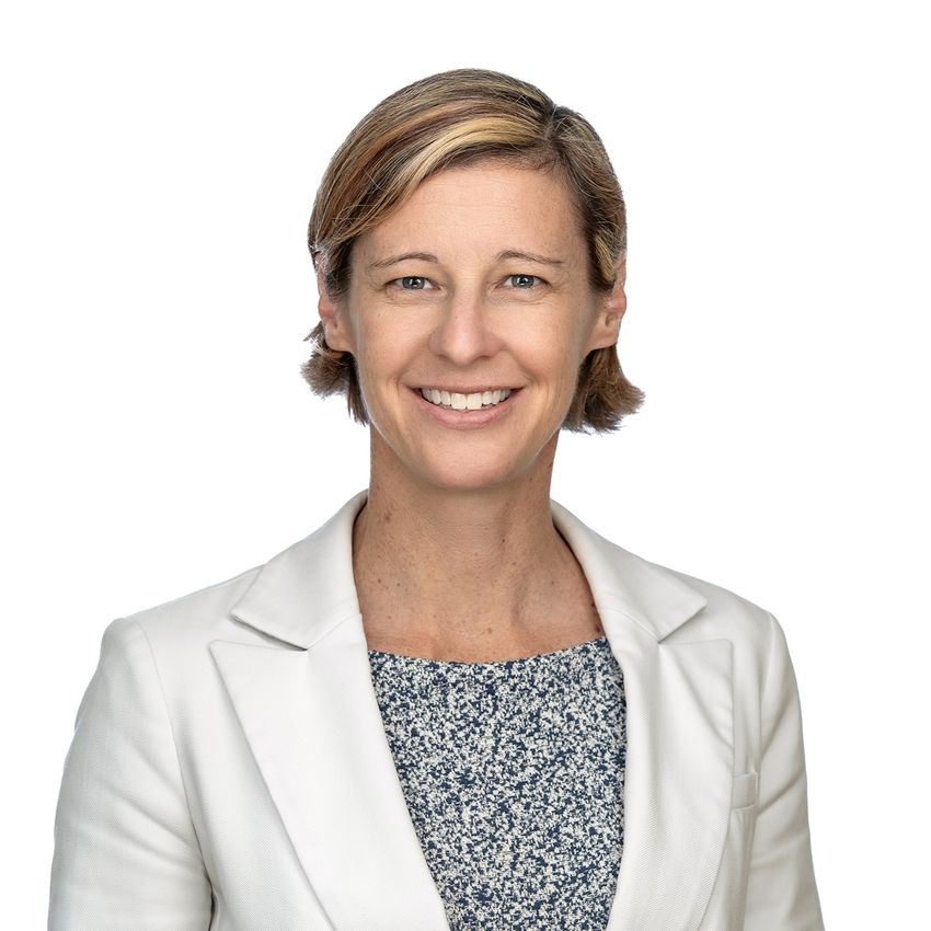 Photograph of Jen Heemstra, a biomolecular engineer at the Washington University in St. Louis on a solid white background. Heemstra has short, light brown and blonde hair and is smiling at the camera. She is wearing a white dress jacket over a blue and white printed top. Photograph of Jen Heemstra, a biomolecular engineer at the Washington University in St. Louis on a solid white background. Heemstra has short, light brown and blonde hair and is smiling at the camera. She is wearing a white dress jacket over a blue and white printed top.