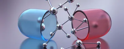 Open capsule or pill with molecular structure. 