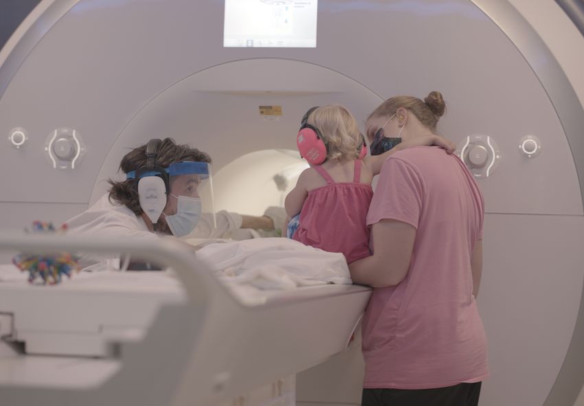 Nicholas Turk-Browne preparing a child and parent for an infant fMRI.