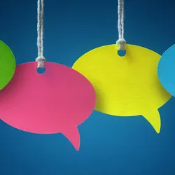 Four colorful speech bubbles hang in front of a blue background.