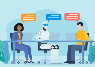 Two employees sit at a desk working on laptops with an AI robot. They have conversation bubbles above them. Two employees sit at a desk working on laptops with an AI robot. They have conversation bubbles above them.
