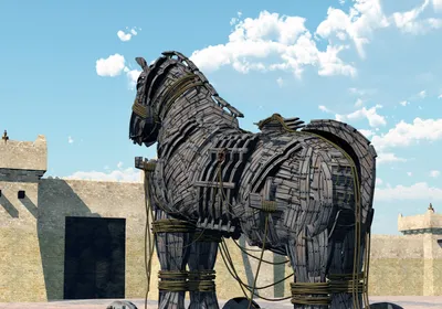 3D illustration of a large wooden horse facing the stone wall of a fortress, representing the Trojan Horse used in the legendary battle of Troy. Researchers used a similar sneaking strategy to improve CAR T cell responses against solid tumors.