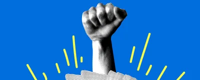 A hand in a fist comes out of an open book against a bright blue background.