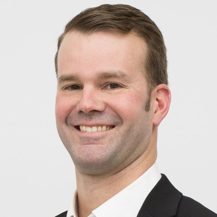 John Chinnici smiles in a professional headshot.