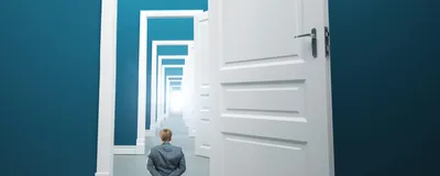 Person standing in front of long way of opened doors, indicating an environment where scientists thrive in an atmosphere that allows them to pursue serendipitous observations. 