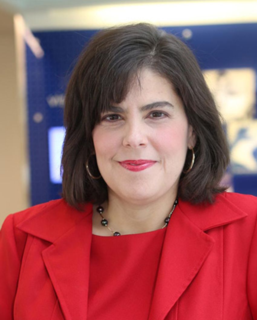 Stacy Lindborg smiles in a red suit.