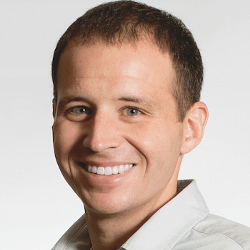 A photograph of Russell Funk wearing a white shirt.