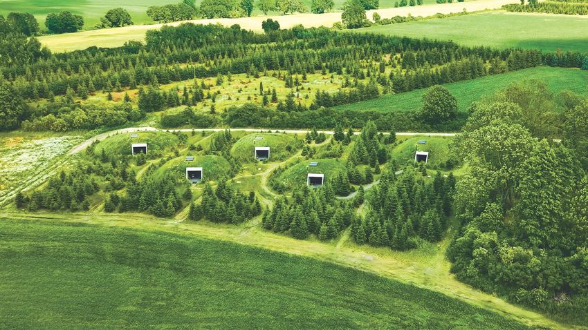 Photo shows individual cave chambers nestled within small hilltops in the countryside.