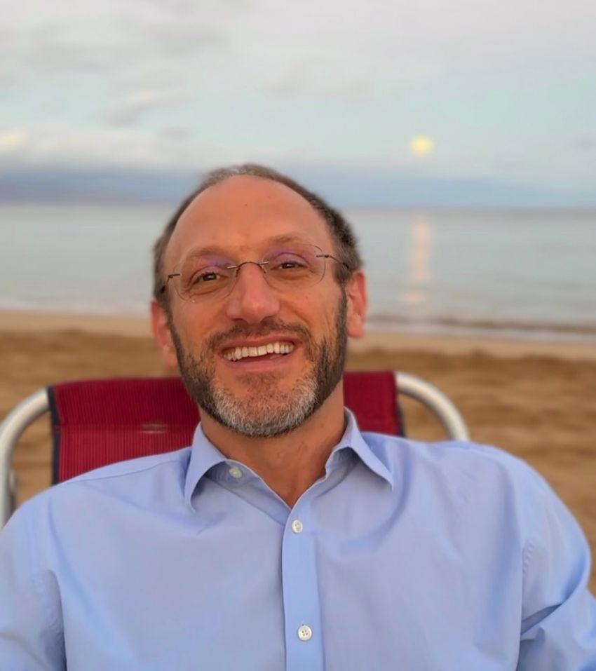 Clinical neuropsychologist Justin Feinstein is sitting on a chair at a beach.  Inline image 3: Open float pool_Flotation REST