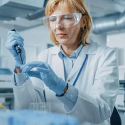 A scientist analyzing samples in droplet digital PCR system to achieve high precision quantification