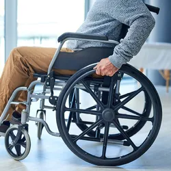 A man in a wheelchair, probably suffering from a spinal cord injury. 