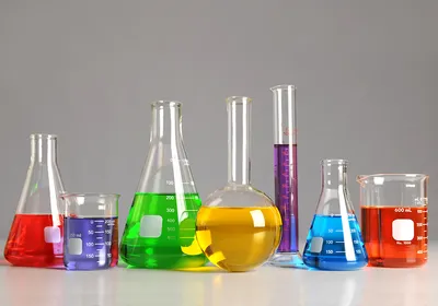 A photograph of laboratory glassware filled with colorful solutions.