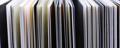 The edges of open pages of scientific journals are shown.