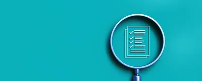 A magnifying glass over a regulatory compliance checklist icon