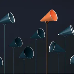 Ten dark blue megaphones and one orange megaphone stand pointing in different directions and at different heights against a dark background. The orange megaphone stands out because of its different color and it is one of the tallest megaphones. 