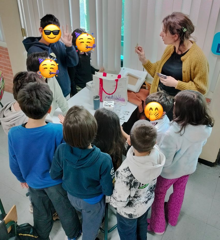 Photograph of Marion Brunck showing a group of third graders her immunology trading cards.