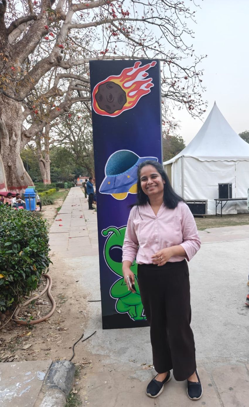 Poorti Kathpalia stands in front of a big banner. Poorti Kathpalia stands in front of a big banner.