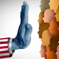 Photo of an arm wearing an American flag sleeve holding a hand up against a crowd of skin-toned silhouettes, representing recent restrictions in hiring international research talent on H-1B visas.
