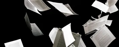 White papers representing scientific publications are shown flying up in the air against a black background.