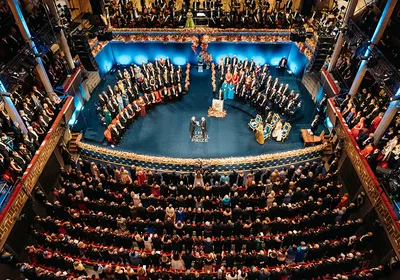A photograph of the 2025 Nobel Prize ceremony being held.