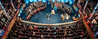 A photograph of the 2025 Nobel Prize ceremony being held.