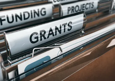 View of brown folders, with focus on grants label, signifying NIH funding that is pushing against relying solely on animal models.