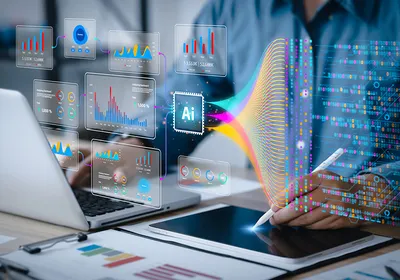 Image of a person working on a computer and a tablet. There is an overlay of AI images and data floating in the air in front of the person.