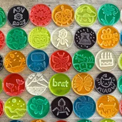 Image of various agar plates of different colors with different images growing on the surface.