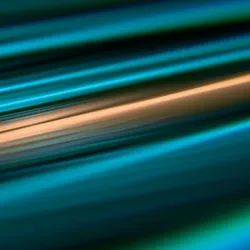 Abstract image of blue, green, and orange lines on a black background. 