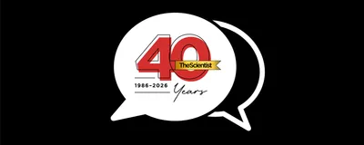 Image of two speech bubbles. Inside the full white speech bubble, there is red text denoting The Scientist 40 Years, 1986-2026.