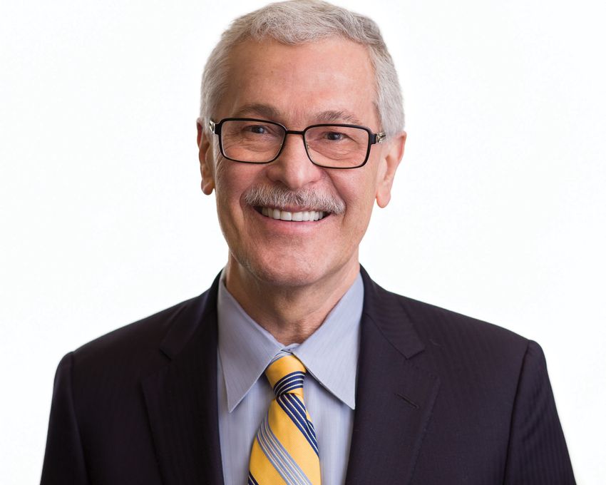 A photograph of Mahmoud Ghannoum wearing a suit against a white background.